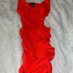 Orange bodycon dress with cutout knotted & criss cross detailing in the front